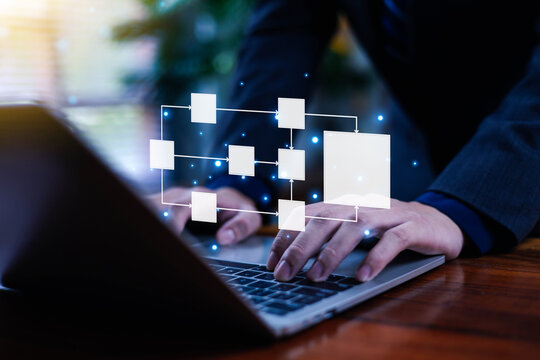 Professional working on a laptop with a digital flowchart overlay, symbolizing workflow management, process automation, data organization, and efficient system planning in modern business today.
