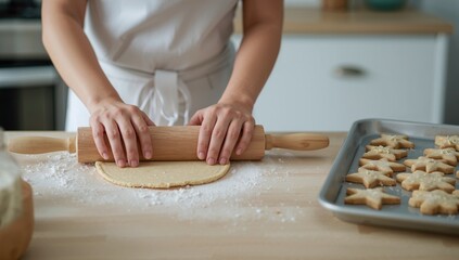 Person shaping dough into star forms for festive baking, holiday preparation