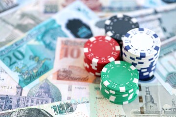 Egyptian pound currency money bills and bunch of casino chips close up. The concept of gambling and casino games
