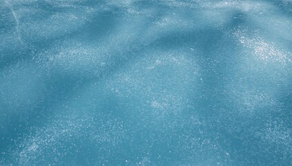 Close-up of a smooth blue ice rink surface illuminated by daylight, ideal for skating activities