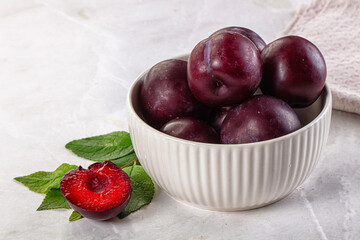 Raw ripe purple plum heap