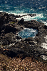Natural volcanic pool at Piscinas Naturales de Los Abrigos on Tenerife. Deep blue water surrounded by dark lava rocks shaped by the Atlantic.