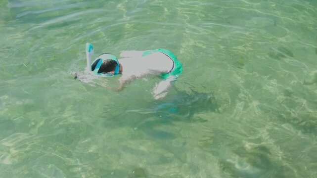 Teenage boy enjoying snorkeling in sea water, enjoying active summer holidays, exploring underwater life with mask and snorkel, Water activities, childhood adventure, marine life