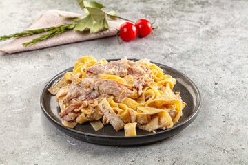 Italian pasta fettuccine with prosciutto