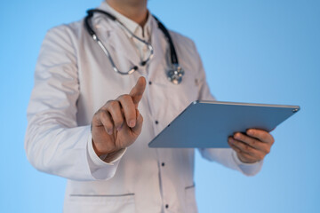 Doctor using digital tablet while touching virtual interface screen with finger, showcasing modern healthcare technology concept on blue background.
