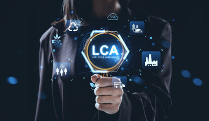 Life Cycle Assessment concept with futuristic interface showing sustainability and environmental analysis icons in hand of businesswoman on dark background.