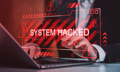 System hacked alert displayed on digital screen with red warning signs and businessman using laptop indicating online security breach concept.