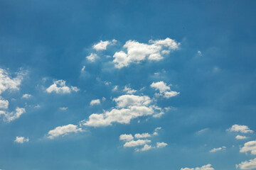 harmonic white puffy clouds under blue sky