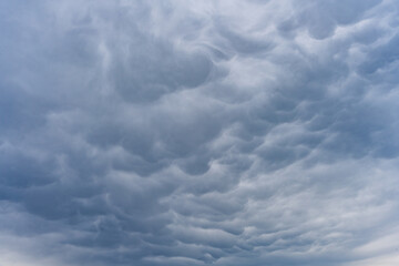 Mammatus clouds expand across the Bavarian sky displaying a rare natural weather event with intense texture in Germany