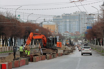 Repairing a heating main under a city street. Preparing for the heating season