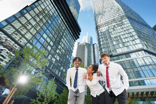 Multicultural young people having fun walking on city street. Happy friends group talking and laughing out loud. Life style concept