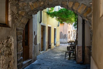 Fotobehang Smalle Straten Passageway with stone arch in the narrow streets of the picturesque town of Piran, Slovenia.  © josemiguelsangar