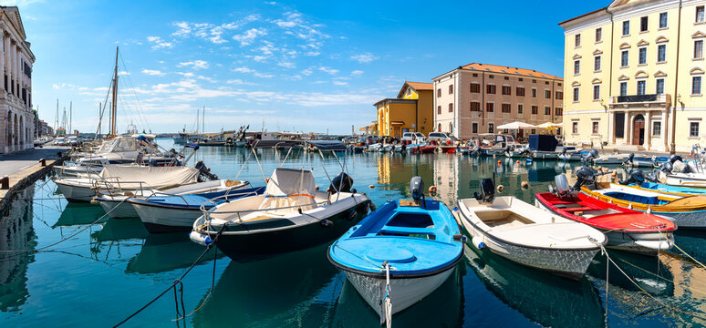 Small pleasure and fishing boats in the harbour of the holiday town of Piran, Slovenia. - Powered by Adobe