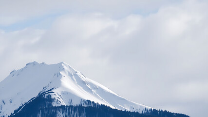 Snow-covered mountain ridge under cloudy sky