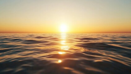 Fototapeta premium A serene sunset over a calm ocean, with gentle waves reflecting warm hues of orange and gold.