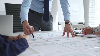 Business people team analyzing financial charts and graphs during strategy meeting in modern office, focusing on corporate planning, and decision making - Powered by Adobe