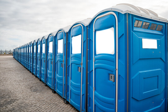 Panoramic view of numerous blue portable public toilets lined up, Lisboa-portugal.