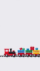 A colorful toy train with a red engine and three cargo cars carrying wrapped presents, set on a simple track against a plain light gray background.
