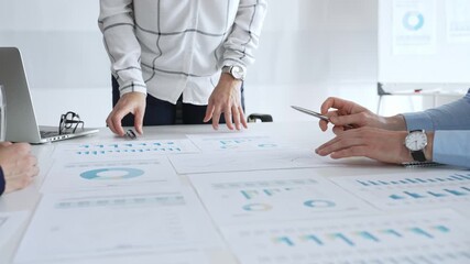 Business people team analyzing financial charts during strategy meeting, professionals discussing data and performance metrics at workplace for decision making success - Powered by Adobe