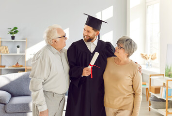 Happy family at home close celebrating adult son graduation awarding of diploma, senior old parents children, conferring of university, college degree, achievement grandson wearing gown and cap