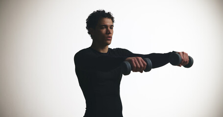 Dumbbells, fitness and strength with man on studio space for bodybuilding or training routine....