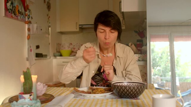 Morning meal tranquility, Calm woman with fair skin savoring straightforward morning meal at her kitchen table