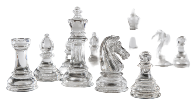  Glass chess pieces arranged on a reflective surface showing clear transparency and intricate details isolated on white background
