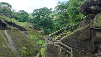 The Somber and Timeless Exterior of the Kanheri Vihara Chambers, Featuring the Hand-Carved Stone Steps and Textured Walls Leading to the Monks' Residential Quarters