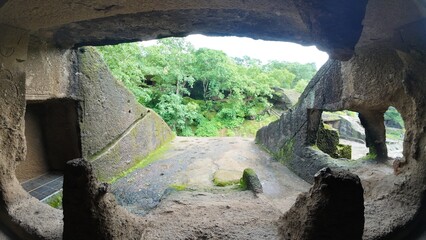 Exploring the Inner Chambers and Viharas of the Ancient Buddhist Rock-Cut Kanheri Caves, Revealing the Simple Living Spaces Used by Monks in Mumbai, Maharashtra.