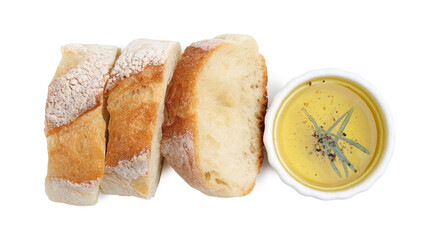 Tasty baguette and oil with rosemary isolated on white, top view