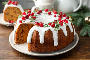 Tasty cake with cranberries and Christmas decor on wooden table, closeup
