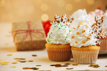 Festive cupcakes with cookies on white table, closeup. Christmas treat