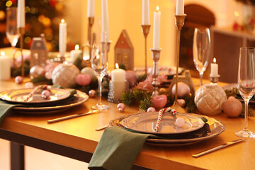 Festive table setting with Christmas decor at home, closeup