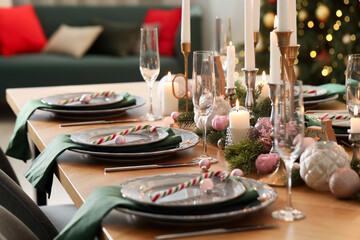 Festive table setting with Christmas decor at home, closeup