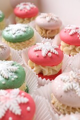 Festively decorated macarons in box, closeup. Christmas treat