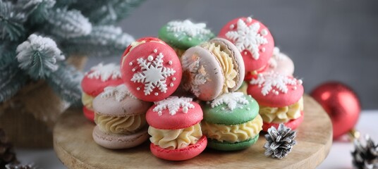 Tasty macarons and Christmas decor on table, closeup