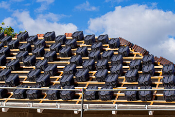 Building house and ceramic tiles over the roof.