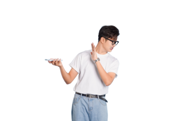 Smart casual: A young man is caught in a moment of surprise, holding a smartphone while warding off something with his other hand, dressed in simple yet stylish attire.