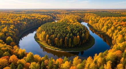Aerial view of winding river through autumn forest with fall colors