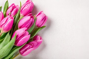 The arrangement of pink tulips set against a soft backdrop is elegant and ideal for springtime festivities and commemorative flower cards