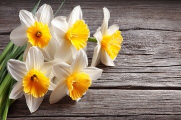 A wooden background is decorated with blooming snowdrop blossoms, signaling the arrival of spring