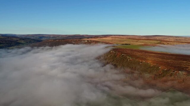 Scenic Cloud Inversion at the Peak District National park in the UK.  Cinematic Drone Landscape Exploration around Froggatt Edge, Curbar Edge and Baslow Edge, which are the most popular hiking trails.