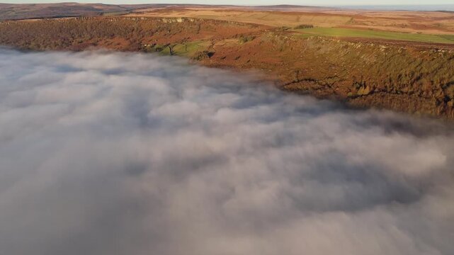 Scenic Cloud Inversion at the Peak District National park in the UK.  Cinematic Drone Landscape Exploration around Froggatt Edge, Curbar Edge and Baslow Edge, which are the most popular hiking trails.