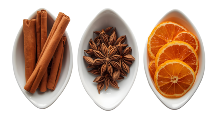 Three white bowls filled with cinnamon sticks star anise and orange slices on a black background on transparent background