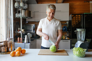 Man preparing fresh vegetables in a modern kitchen