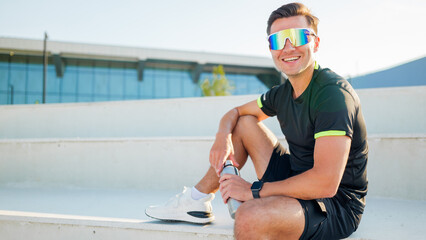Young man relaxing after workout in sportswear