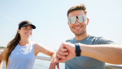 Two friends are enjoying a run by the water