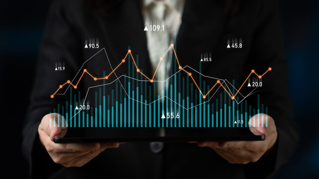 A business professional showcases a digital tablet featuring vibrant data charts and graphs, illustrating market trends and performance metrics essential for strategic decision-making. Scalp