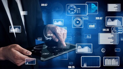 A businessman interacts with a tablet displaying various data visualizations and analytics in a contemporary office environment, showcasing modern business insights. Xenic