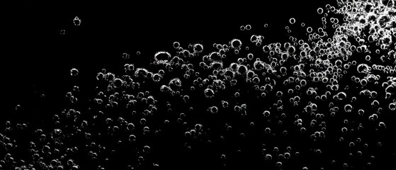 Fototapeta premium Soda water bubbles splashing underwater against black background, cola liquid texture fizzing and floating to surface like an explosion for refreshing carbonate drink concept.